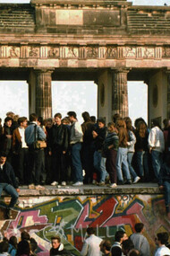 This Nov. 10, 1989 file photo shows Germans from East and West standing on the Berlin Wall in front of the Brandenburg Gate, one day after the wall opened