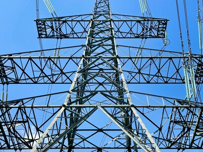 Electricity pylons in front of the cooling towers at the Lethabo thermal power station, a coal-burning Eskom power station near Sasolburg in the northern Free State province, South Africa