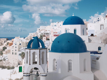 The iconic blue domes and white wall of Santorini, Greece