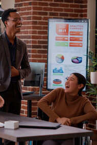 In an open office space, colleagues work together on a shared digital platform, reflecting how AI is transforming the way teams collaborate remotely, from anywhere in the world