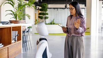 Woman interacting with a service robot in a modern office environment
