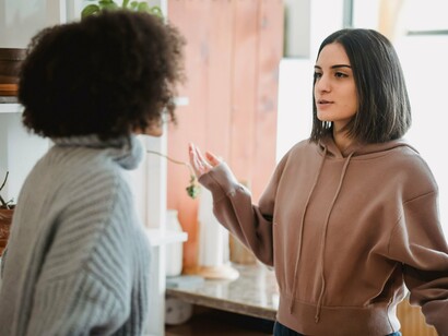 Two people expressing opposing viewpoints face-to-face, reflecting the challenges of managing differences through conversation
