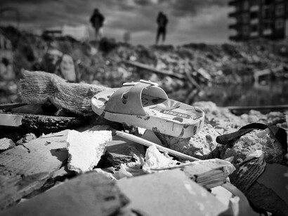 Sandals above the rubble of an earthquake