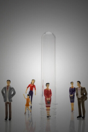 Individuals inside glass tubes, reflecting on social identity and cultural diversity