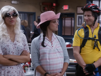 A cheerful ensemble cast of Brooklyn Nine-Nine in their everyday chaos, representing the soothing rhythm of comfort viewing
