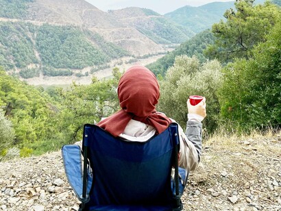 Traveling solo can provide its own comforts amongst the mountains and hills while sipping on a warm beverage and admiring the view