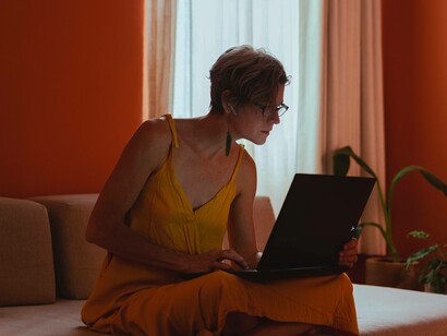 A woman scanning her laptop for a way to combat the disease of "every man for himself"