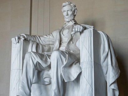 The statue of Abraham Lincoln in Washington, D.C. seated solemnly, reflecting the enduring ideals of democracy and equality