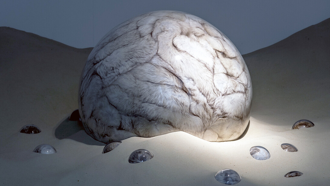 Adeline de Monseignat, Mother HEB Loleta, 2012, Vintage Fur, pillow filler, glass, motor, wood on 2 tonnes of sand, Variable  installation, Courtesy the artist and Ronchini Gallery