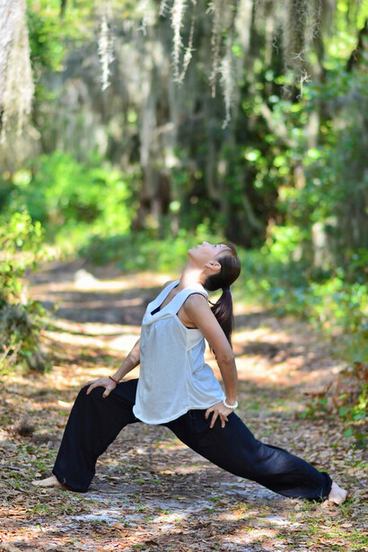 A serene woman gracefully practicing qigong amidst the tranquil woods
