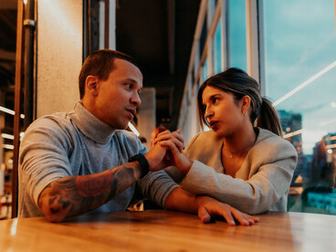 A couple sharing an intimate conversation at a charming Buenos Aires café, reflecting connection and companionship