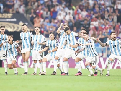 Lionel Messi of Argentina celebrates with teammates in the penalty shootout