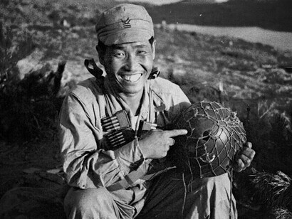 A soldier displaying his helmet during the Korean War