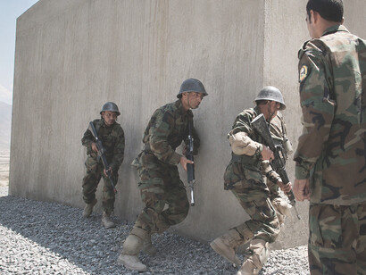 An Afghan National Army instructor observes soldiers during a Military Operations in Urban Terrain (MOUT) exercise in Kabul, Afghanistan