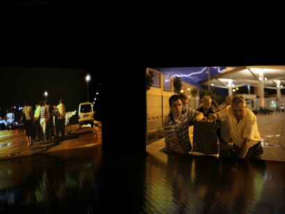 Liminal Crossing, 2009. Two channel synchronized (1920x1080) HD video installation, sound. Duration: 7:45 min. Courtesy the artist, Ludwig Forum für Internationale Kunst, Aachen and Rampa, Istanbul. Installation view Ludwig Forum für Internationale Kunst, Aachen, 2009. © Ergin Çavuşoğlu