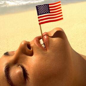Albert Watson, Cindy Crawford with flag, U.S. Virgin Islands, 1993. Courtesy of Fahey/Klein Gallery