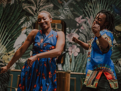 A woman elegantly dancing with a man in a matching blue shirt