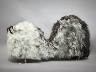 Unique Hairy J. Blige double-hump bench from the Beast series, in Salt N' Peppa Icelandic sheep fur, with carved ebony horns, cast bronze lion feet, and cast bronze tits and a pussy. Designed and made by The Haas Brothers, Los Angeles, CA, 2014. 93" L x 38" W x 50" H / 236.2cm L x 96.5cm W x 127cm H. Photograph by Joe Kramm/R & Company