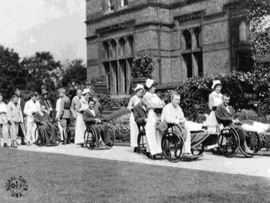 Wounded soldiers being wheeled about the grounds of the American Red Cross Military Hospital, Unit T, Mossley Hill, Liverpool, England. 10th August 1918, © IWM 