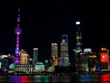 Modern skyscrapers rising above the waterfront in Shanghai, China, symbolizing China's rapid urbanization and technological advancement