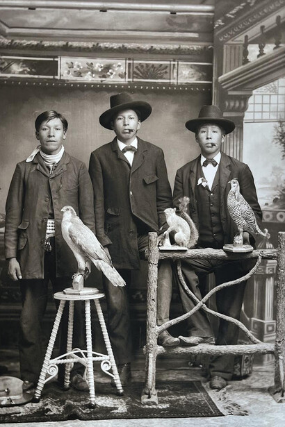 Charles Van Schaick, Henry Greencrow (CooNooZeeKah), William Hall (HunkKah), and Charlie Greengrass (HoeHumpCheeKayRayHeKah) pose with two stuffed birds and a stuffed squirrel, ca. 1898. Courtesy of Portrait Society