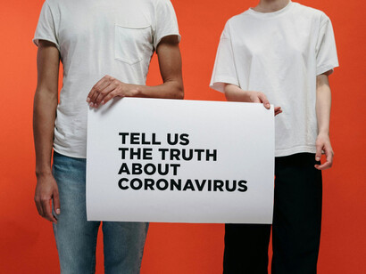 A duo demanding the truth about COVID-19, symbolizing the struggle to discern science from suspicion