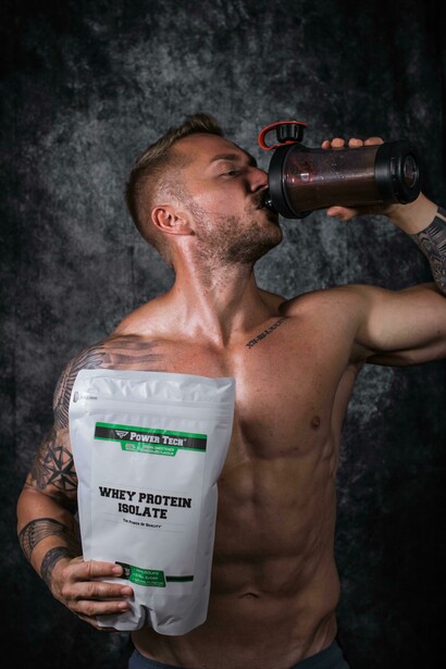 Athletic shirtless man flexing his muscles, highlighting whey protein use for strength training