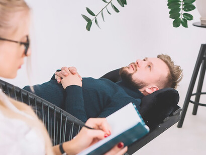 Embark on a journey of healing with a compassionate female psychologist documenting insights in her diary as her patient finds solace on a clinic couch, fostering mental well-being and growth through tailored support