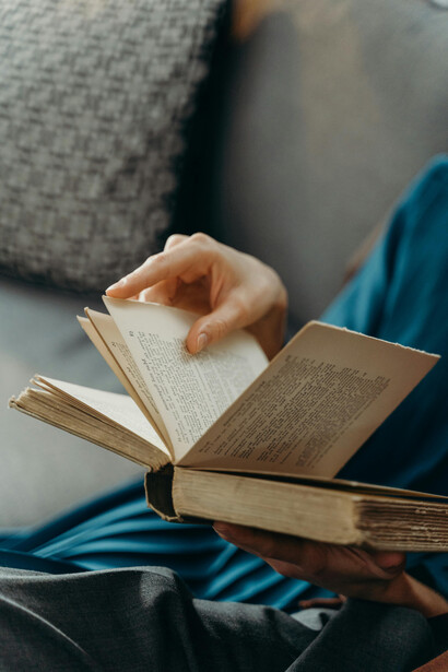 Close-up of a person holding a book, symbolizing wisdom, knowledge, and experience
