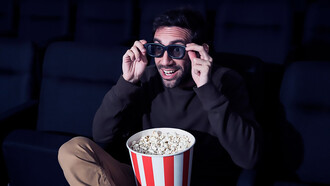Man enjoying popcorn in movie theater