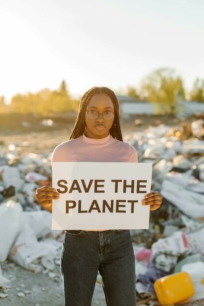 A young activist holds a sign symbolizing the urgent call for environmental justice 