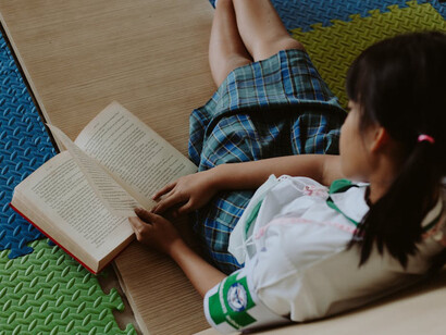 Girl at school reading a book, determined to develop her mind, determined to gain knowledge