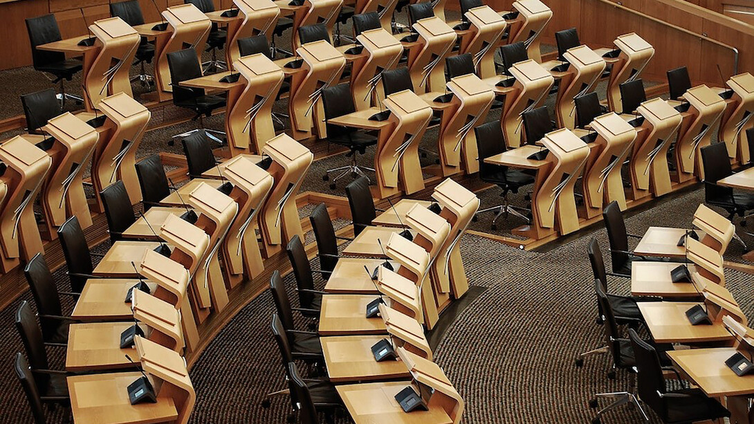 The desks inside of the parliament building symbolize the heart of democracy, where crucial decisions are made to shape the future of society