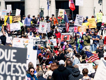 A demonstration unfolds at the Utah State Capitol as protesters raise signs against the actions of Donald Trump and Elon Musk, USA