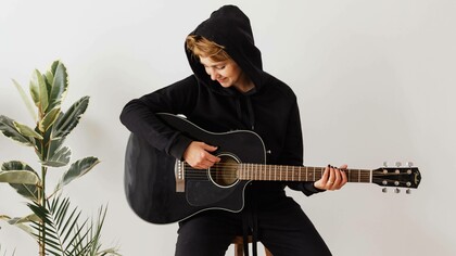 Person playing the acoustic guitar