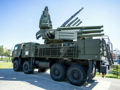 An outdoor display of a military missile defense system, representing the growing militarization of global security strategies