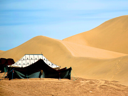 A traditional Berber tent in M'hamid El Ghizlane, representing the enduring nomadic heritage of the Moroccan Sahara