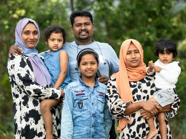 Joyful migrant family smiling and posing together