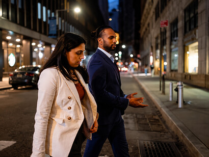 Executives walking between office buildings in the evening cityscape