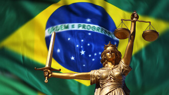 Statue of justice in front of the flag of Brazil