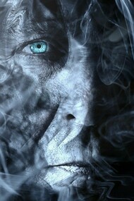 A face shrouded in smoke, showing a hint of human suffering and vulnerability