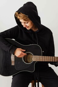 Person playing the acoustic guitar