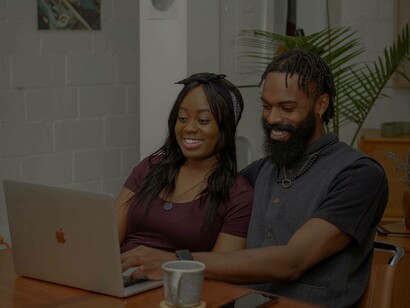 A smiling couple enjoying their latest purchases through the e-commerce verse