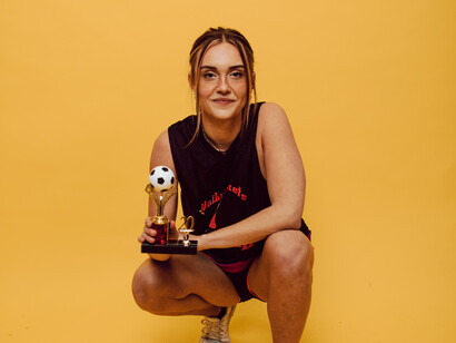 A woman holds her trophy won