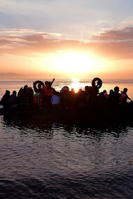 Syrian migrants in an overcrowded dinghy from Turkey arrive on the Greek island of Kos