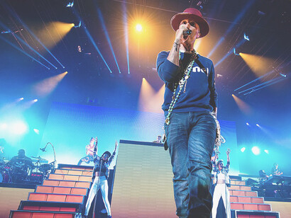 Pharrell Williams performing live in 2014, showcasing his influential streetwear and fashion sense