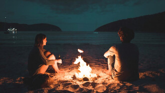 Couple chilling at the bonfire in Tasmania, Australia