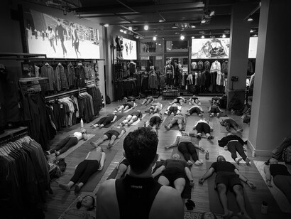 An instructor leads a breathwork class of many students