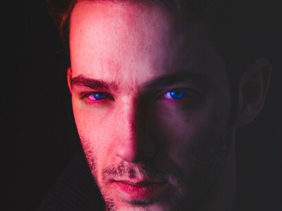 After undergoing a Keratopigmentation process this man is staring menacingly with his deep blue eyes