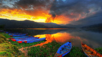 Golden sunset reflecting over Phewa Lake in Pokhara, Nepal